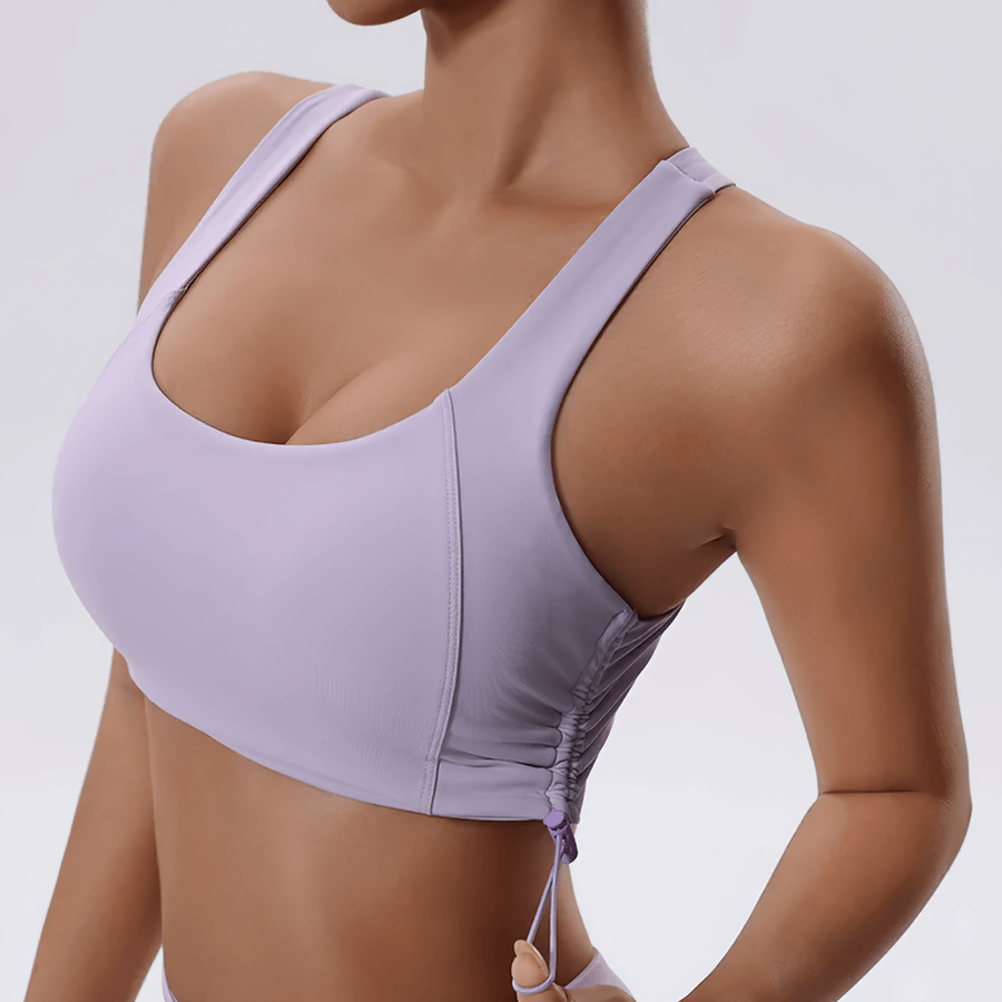 Woman wearing a sexy adjustable sports bra in lavender, ideal for yoga and high-impact workouts, featuring breathable back design.